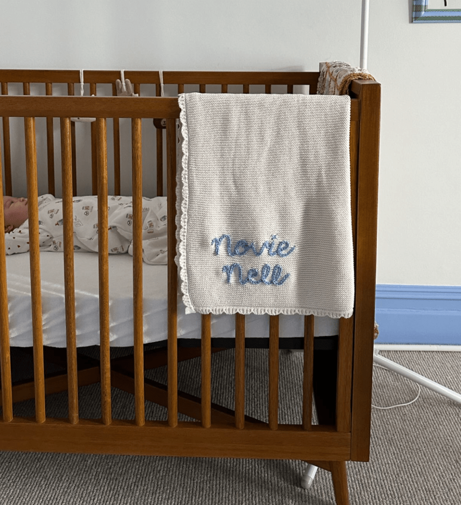 Personalized name decor in Ottilie and Noviee’s rooms, featuring custom wooden name signs and embroidered pillows that add a sentimental touch to the space.