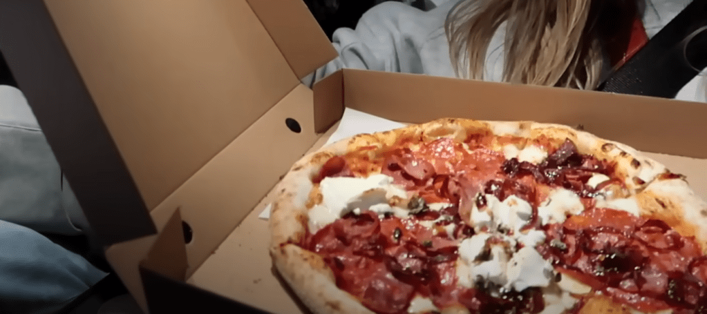 Alfie Deyes with their order from Pizza Face in Hove, UK.