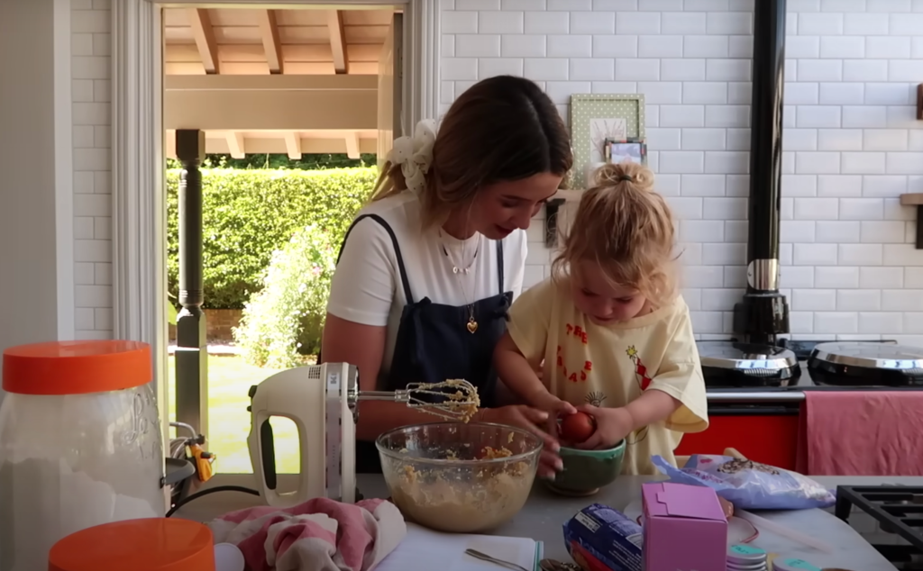 Zoe Sugg and Ottilie mixing cookie dough together.