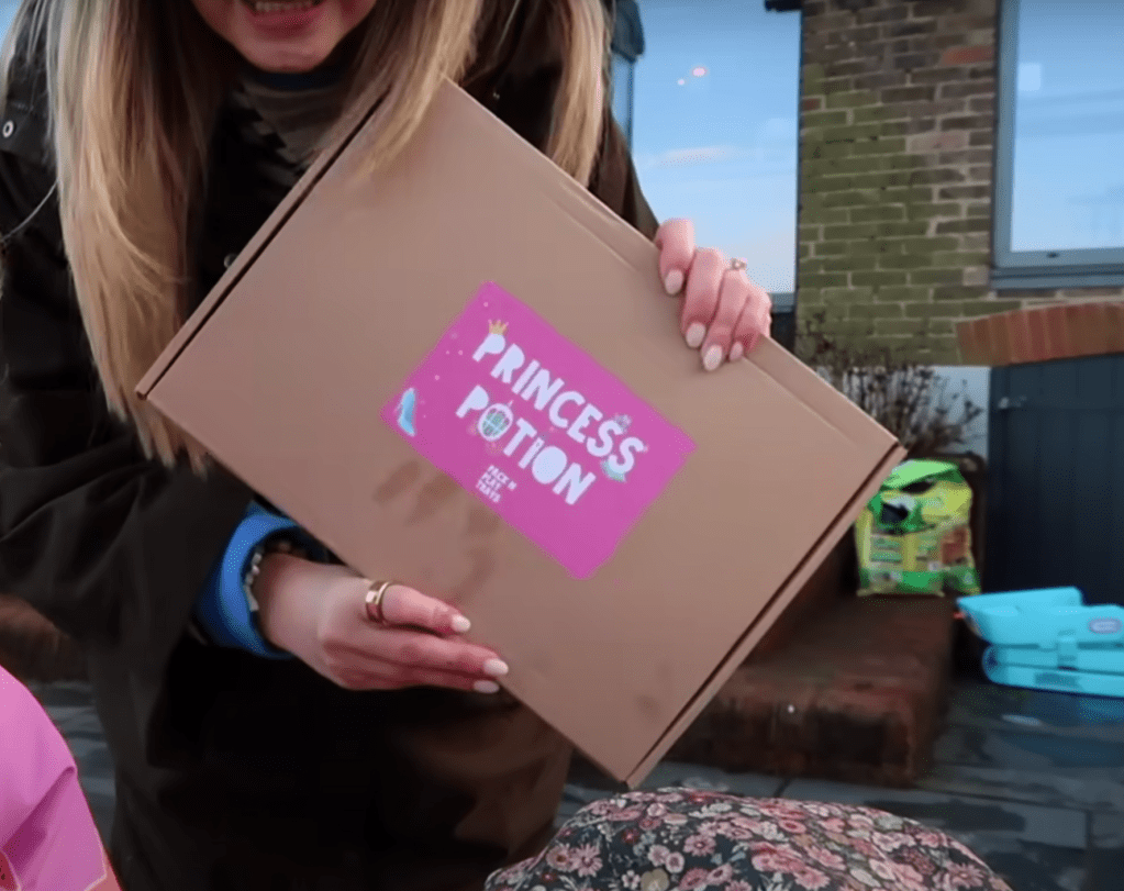 Zoe Sugg holding the Princess Potion Kit, a magical sensory play kit for kids.