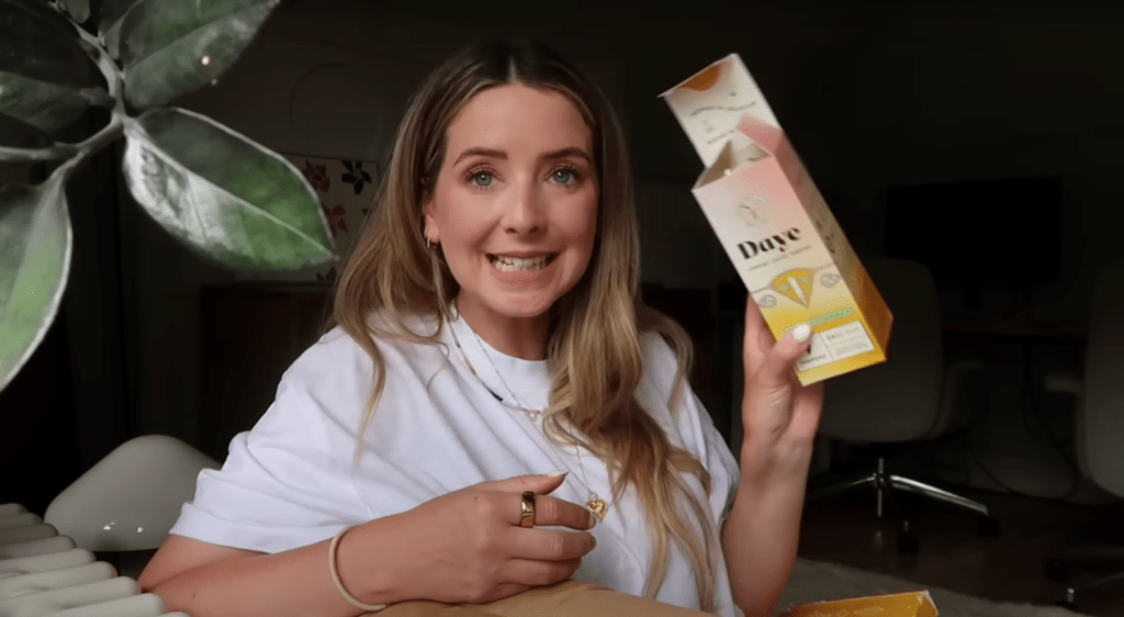 Zoe Sugg holding a box of Daye CBD-infused tampons, explaining their pain-relieving properties.