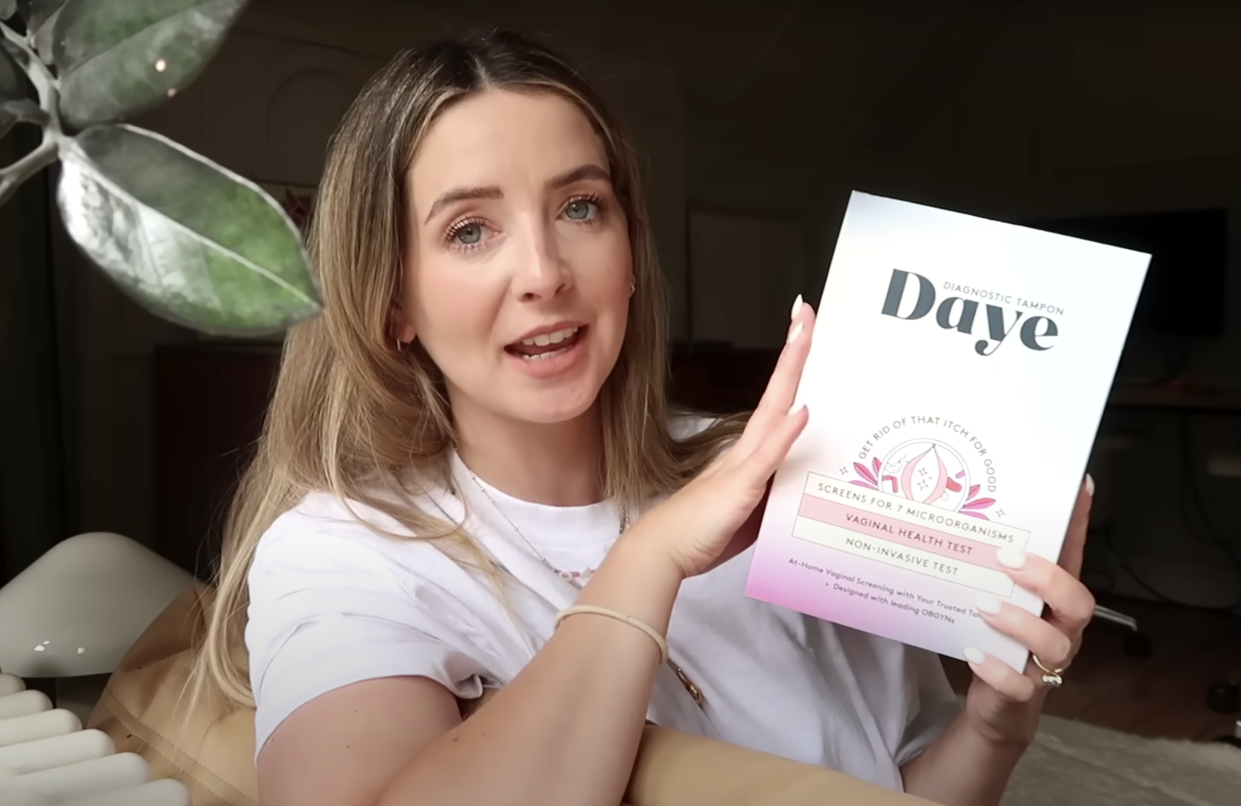 Zoe Sugg holding a Daye diagnostic tampon box, discussing at-home vaginal health screening.