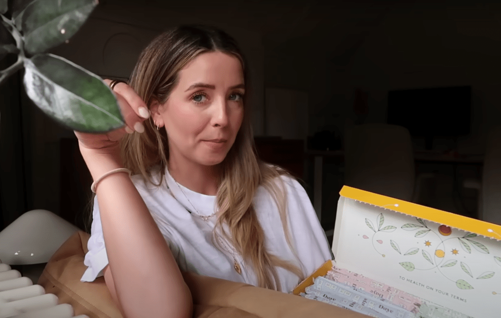 Zoe Sugg opening a box of Daye tampons, revealing their sustainable and CBD-infused options.