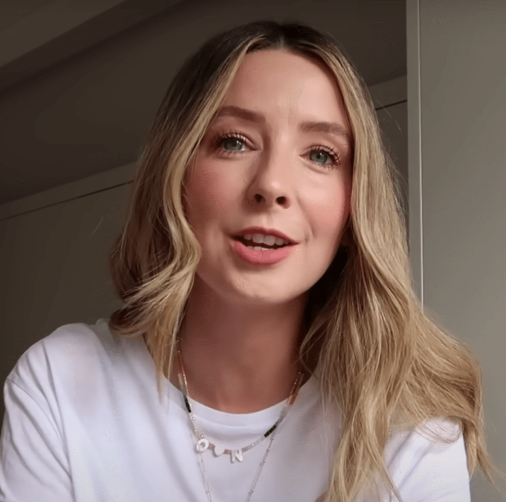 Zoe Sugg wearing a beaded necklace with "O N" initials.